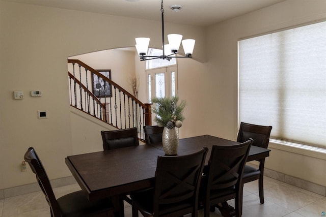 7926 S County Rd A, Superior, WI 54880 - dining area featuring a chandelier, light tile patterned flooring, and stairway