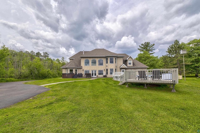7926 S County Rd A, Superior, WI 54880 - rear view of house featuring a deck, a yard, and a shingled roof