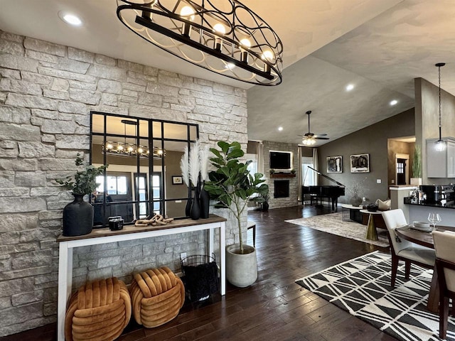 living room with ceiling fan, lofted ceiling, recessed lighting, a large fireplace, and hardwood / wood-style floors