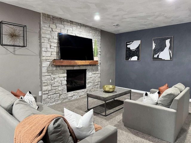 carpeted living area with a stone fireplace