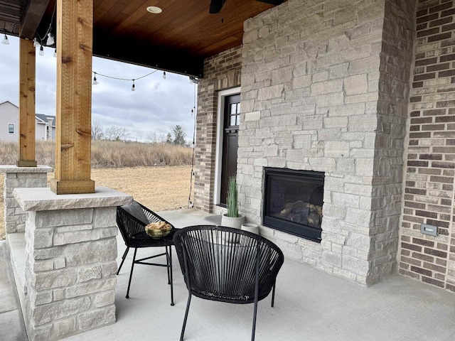 view of patio / terrace with an outdoor stone fireplace