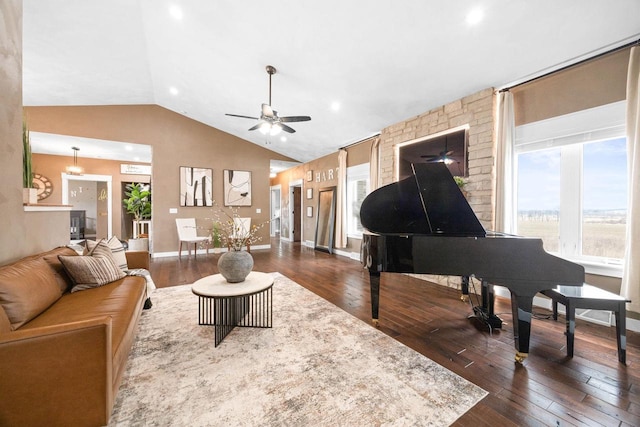 living area featuring lofted ceiling, dark wood-style flooring, a ceiling fan, and baseboards