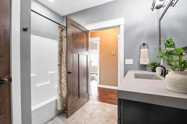 full bathroom featuring shower / bath combo with shower curtain and vanity