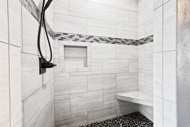 full bathroom with a tile shower