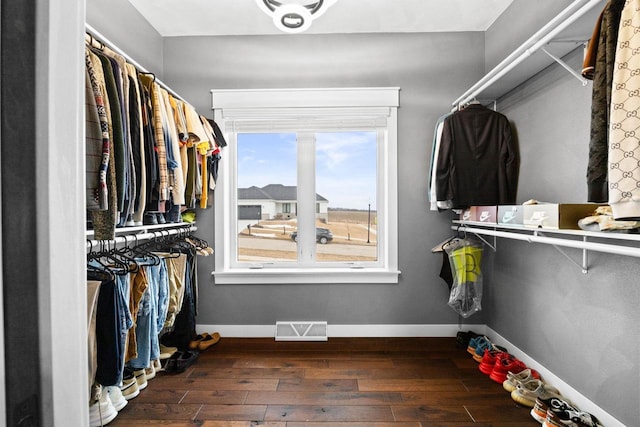 spacious closet featuring wood finished floors and visible vents