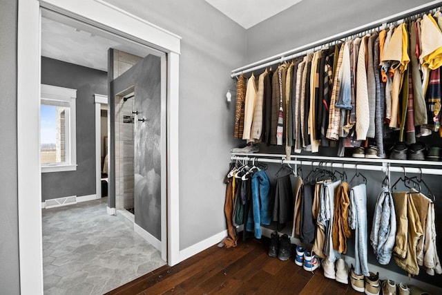 spacious closet with visible vents and hardwood / wood-style flooring