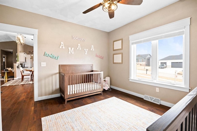 bedroom featuring wood-type flooring, visible vents, and baseboards