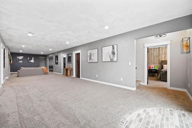 unfurnished living room featuring recessed lighting, carpet flooring, and baseboards