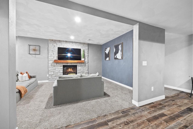 living area with dark wood-style floors, a fireplace, and baseboards