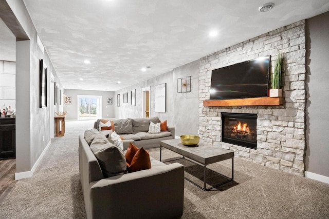 carpeted living room featuring a fireplace and baseboards