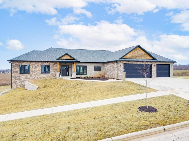 view of front of house featuring driveway, a front lawn, roof with shingles, and an attached garage