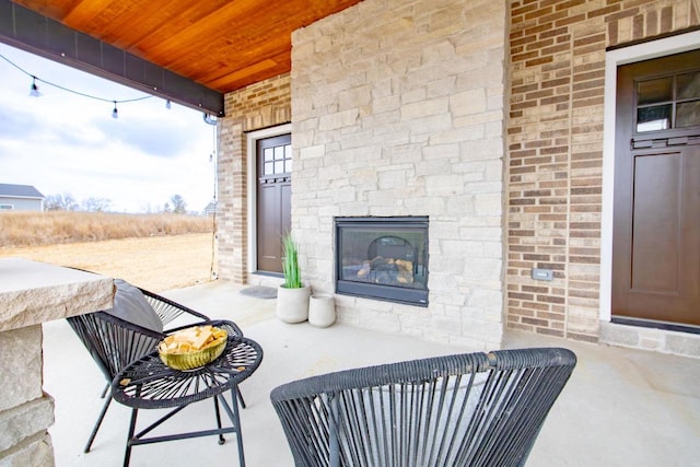 view of patio / terrace featuring an outdoor stone fireplace