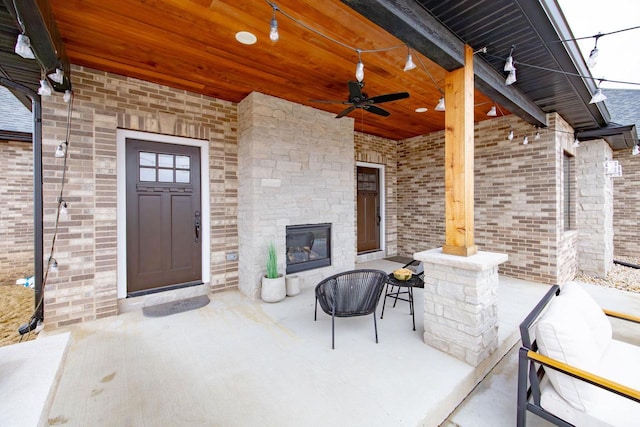 exterior space with a patio, a ceiling fan, and brick siding