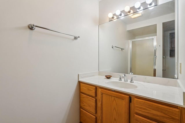 full bath with a stall shower and vanity