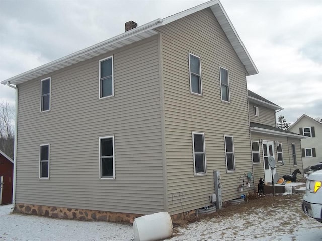 view of home's exterior with a chimney