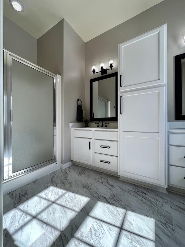 full bathroom with marble finish floor, a shower stall, and vanity