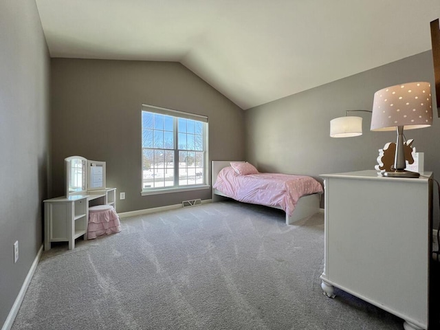 unfurnished bedroom with carpet, baseboards, visible vents, and vaulted ceiling