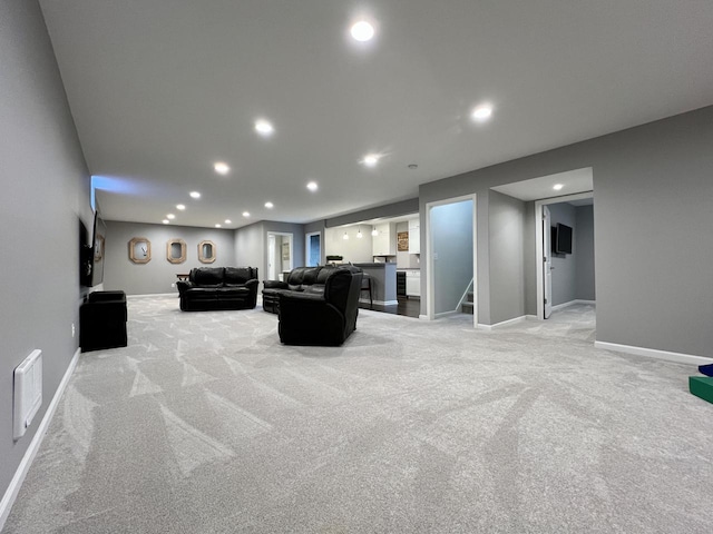 living room featuring light carpet, visible vents, baseboards, stairs, and recessed lighting