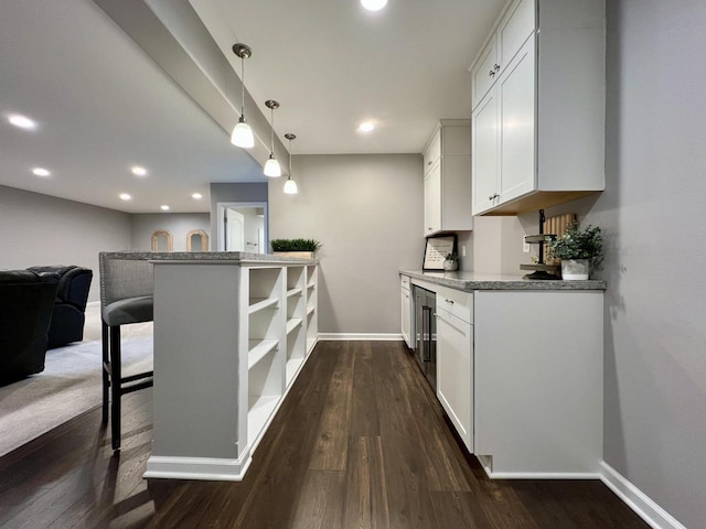 bar with wine cooler, recessed lighting, dark wood-style flooring, baseboards, and pendant lighting