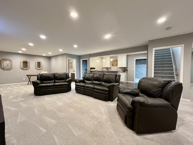 living room with recessed lighting, light colored carpet, stairway, and baseboards