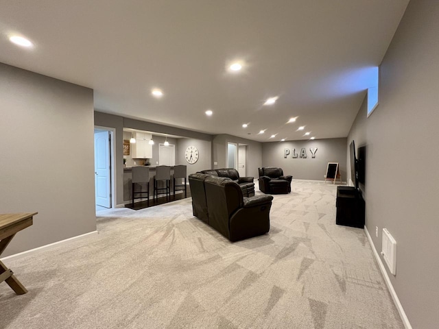 living room featuring recessed lighting, baseboards, and light colored carpet