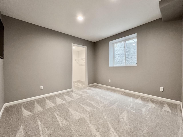 spare room with carpet and baseboards