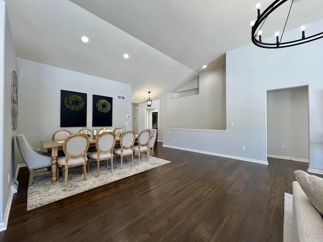 dining space with a chandelier, visible vents, baseboards, vaulted ceiling, and dark wood finished floors