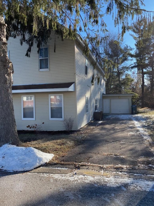 view of home's exterior with a garage and aphalt driveway