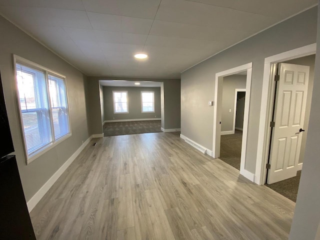 interior space featuring baseboards and light wood-style floors