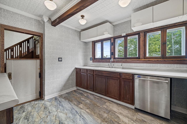 kitchen featuring light countertops, ornamental molding, a sink, dishwasher, and baseboards