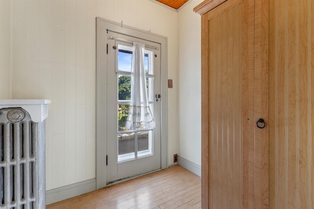 entryway featuring light wood finished floors and radiator heating unit