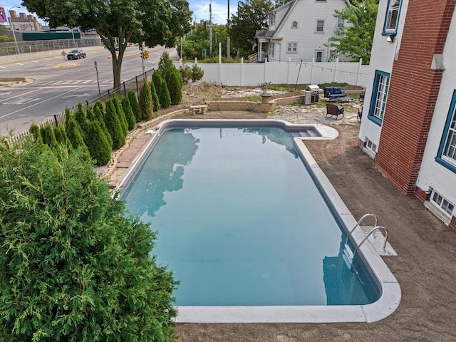 view of swimming pool with a fenced backyard and a fenced in pool