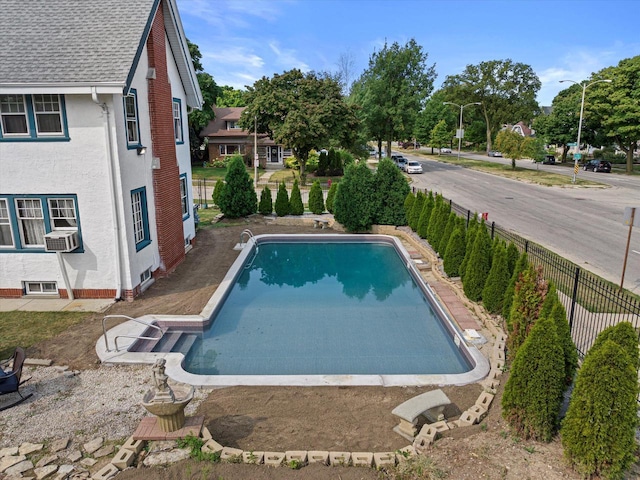 view of pool featuring a fenced in pool, cooling unit, and fence