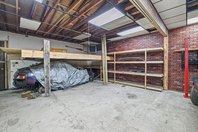 interior space with concrete floors and brick wall