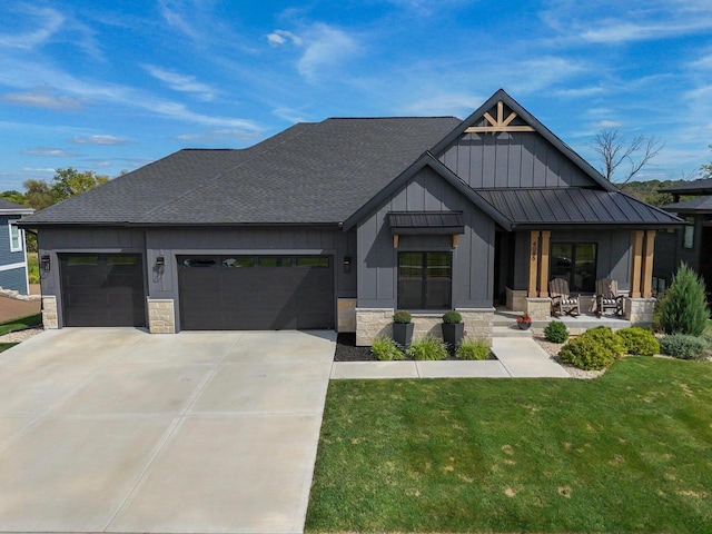 view of front of house featuring concrete driveway, board and batten siding, a standing seam roof, a garage, and stone siding