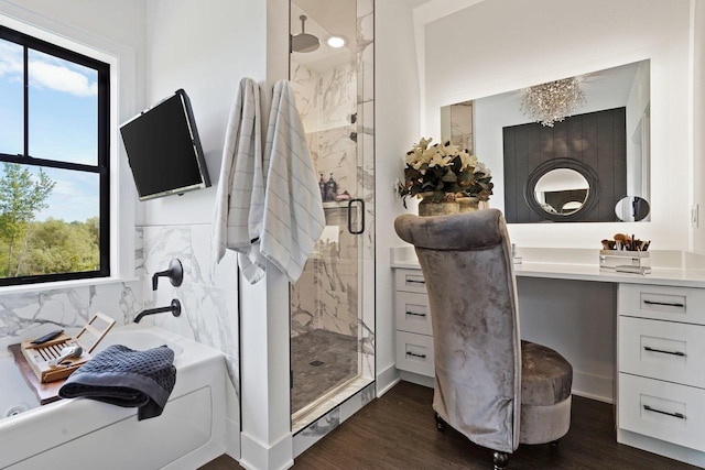 full bath featuring vanity, a marble finish shower, and wood finished floors