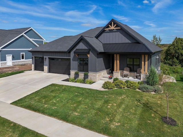 view of front facade with concrete driveway, board and batten siding, a standing seam roof, a garage, and stone siding