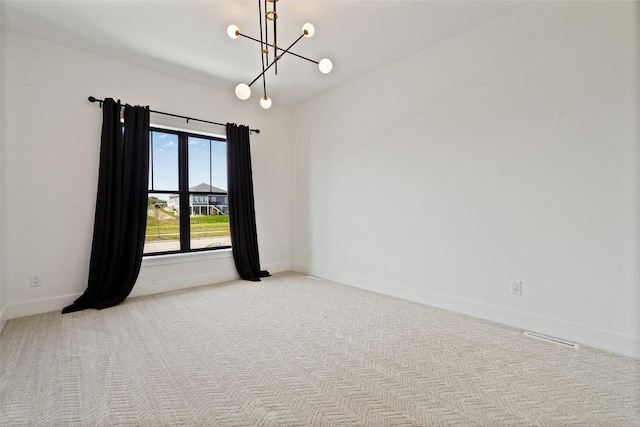 unfurnished room with baseboards, carpet flooring, visible vents, and an inviting chandelier