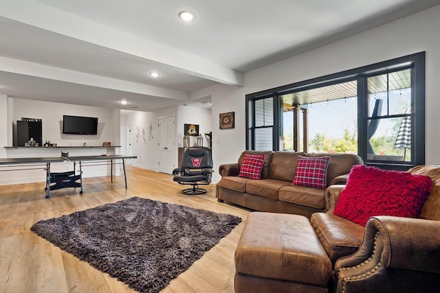 living room with recessed lighting, beamed ceiling, and wood finished floors