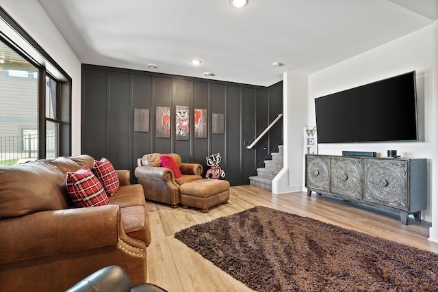 living area with stairway, light wood-type flooring, and recessed lighting