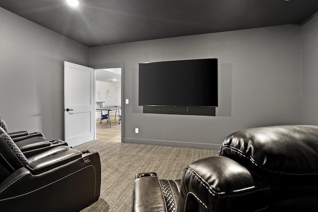 home theater room featuring carpet and baseboards