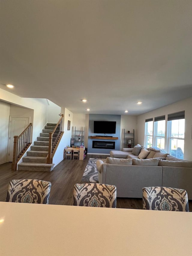 living area featuring stairway, wood finished floors, and recessed lighting