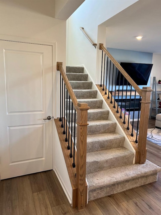 stairway with wood finished floors