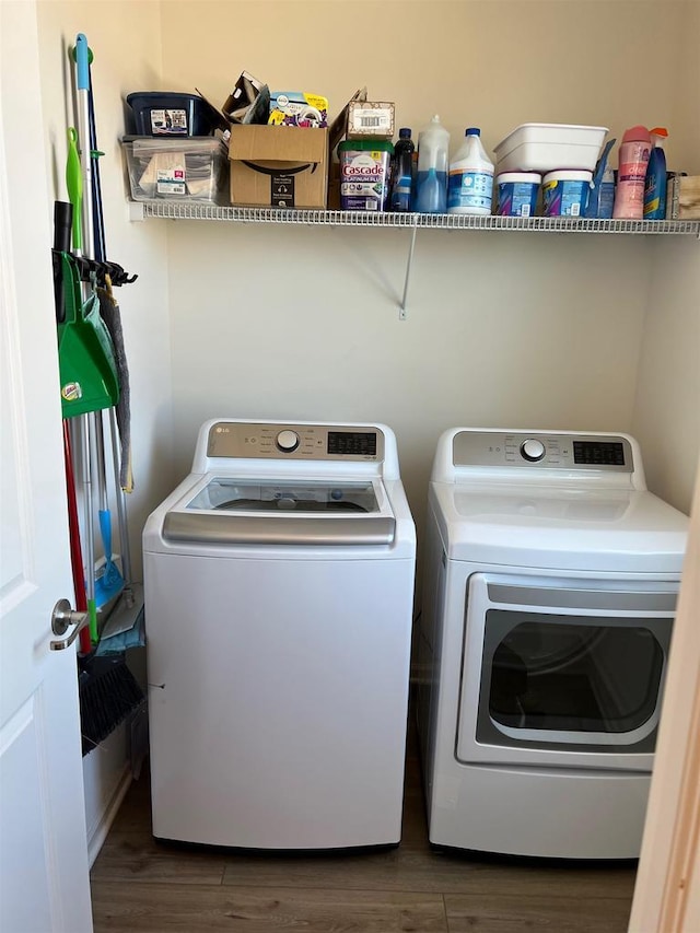 laundry room featuring laundry area, washer and clothes dryer, and wood finished floors