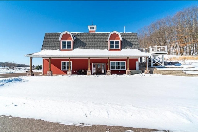 view of snow covered rear of property