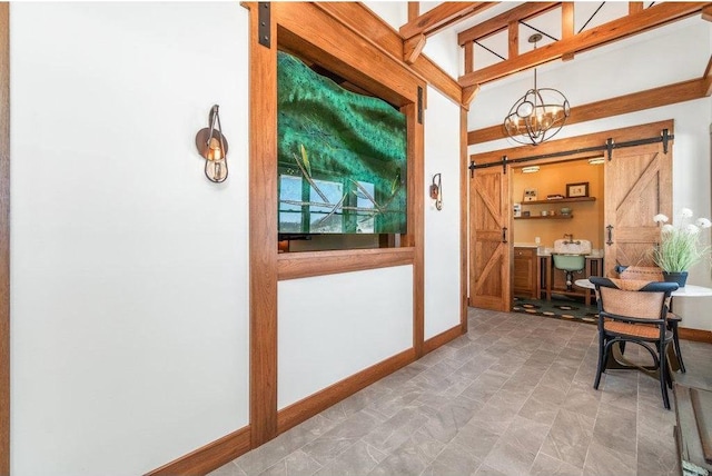 interior space featuring a barn door and baseboards