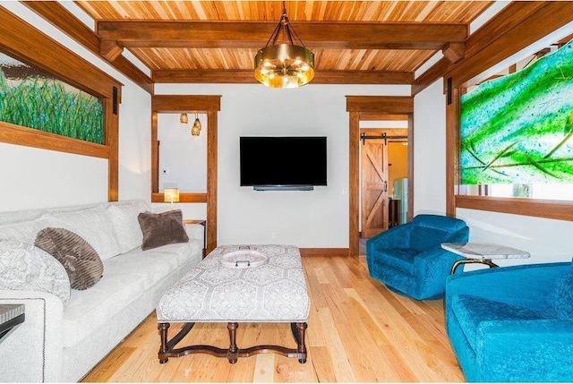 living room with wooden ceiling, light wood-style floors, a barn door, and beamed ceiling