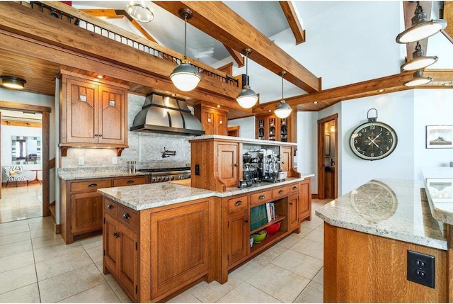 kitchen featuring a center island, brown cabinets, hanging light fixtures, and wall chimney exhaust hood