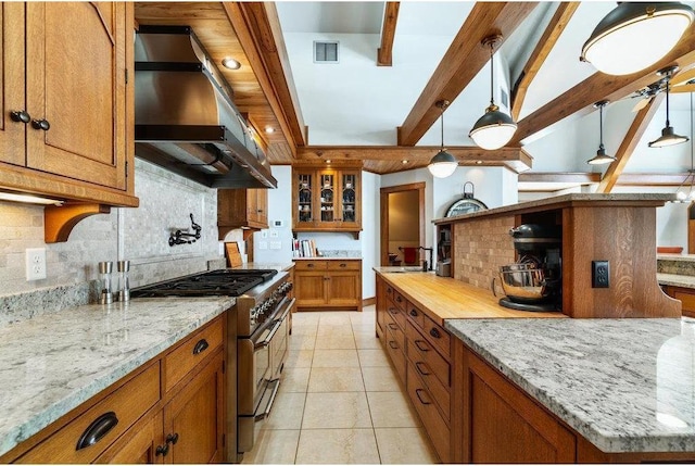 kitchen featuring extractor fan, high end stainless steel range oven, decorative light fixtures, and brown cabinets