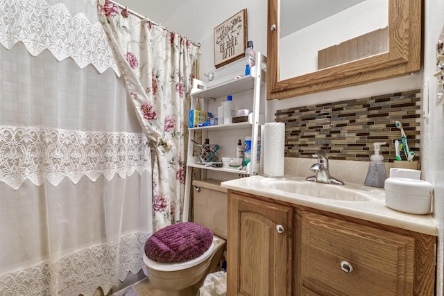 bathroom featuring toilet, tasteful backsplash, and vanity